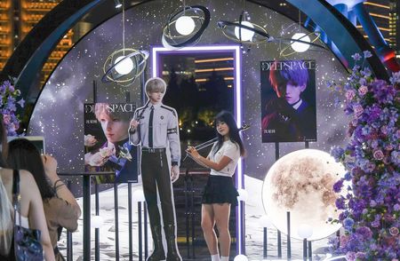 Chinese fangirls posing with Love and Deepspace characters
