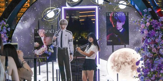 Chinese fangirls posing with Love and Deepspace characters