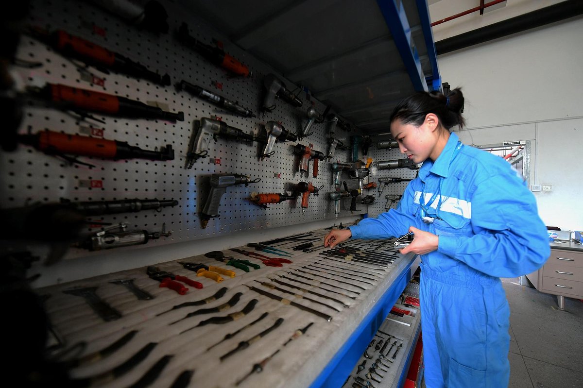 Female airline technician for Xiamen airlines going through through tools