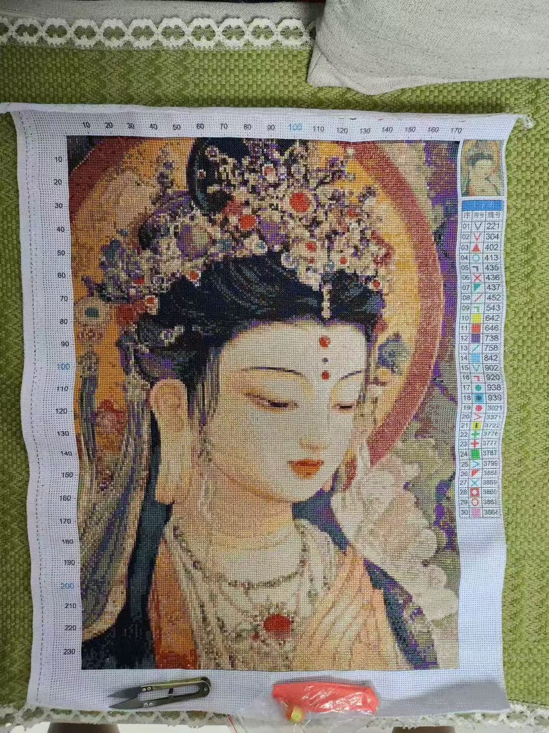 Chinese student cross-stitching work of a Buddha, china urban youth stitching
