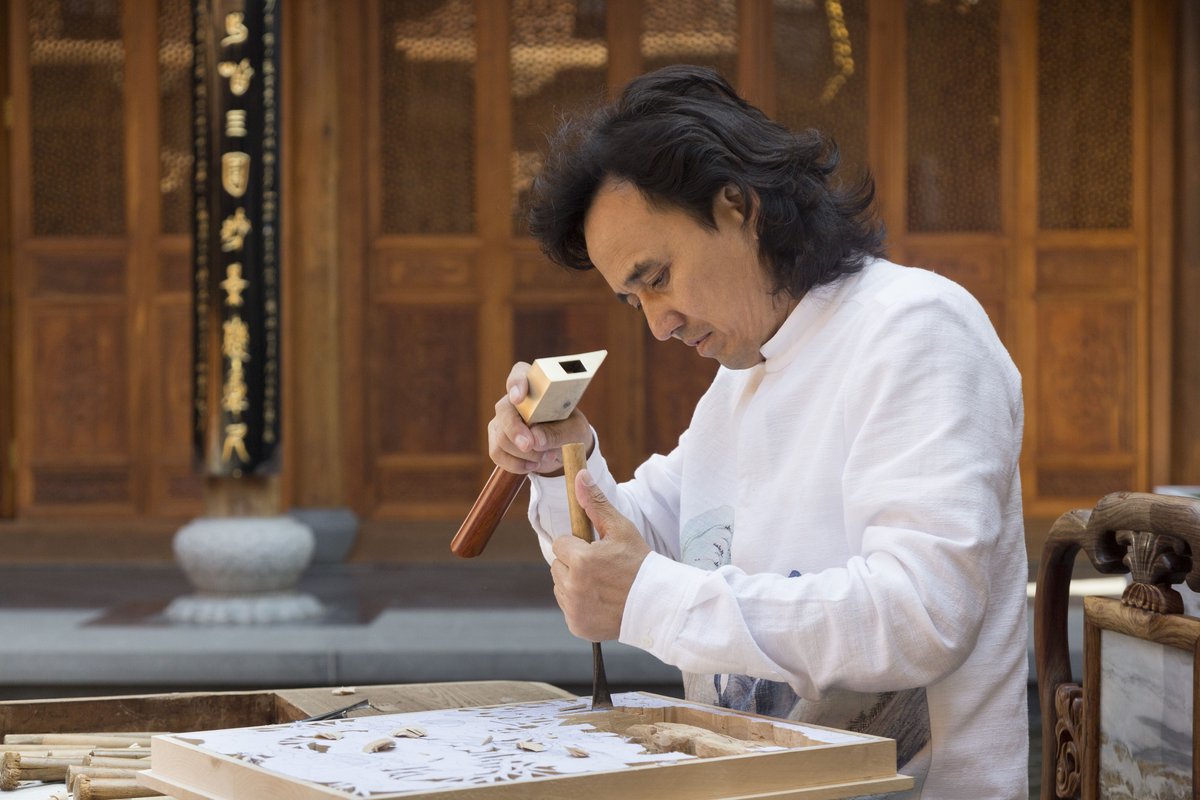 Huang Xiaoming began woodcarving at 16 and has brought a modern twist to this ancient art. He is a national-level inheritor of Dongyang woodcarving, with works collected by the Palace Museum, the Nati