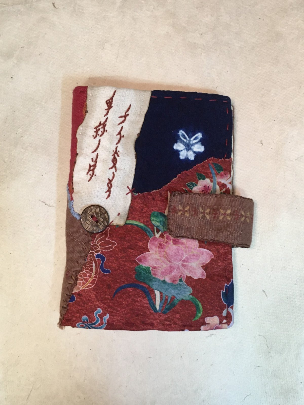 Zhou Yuyue’s crafted booklet, with Nüshu script embroidered on the cover, reads: “Women across the world are sisters of one family” (courtesy of Zhou Yuyue)