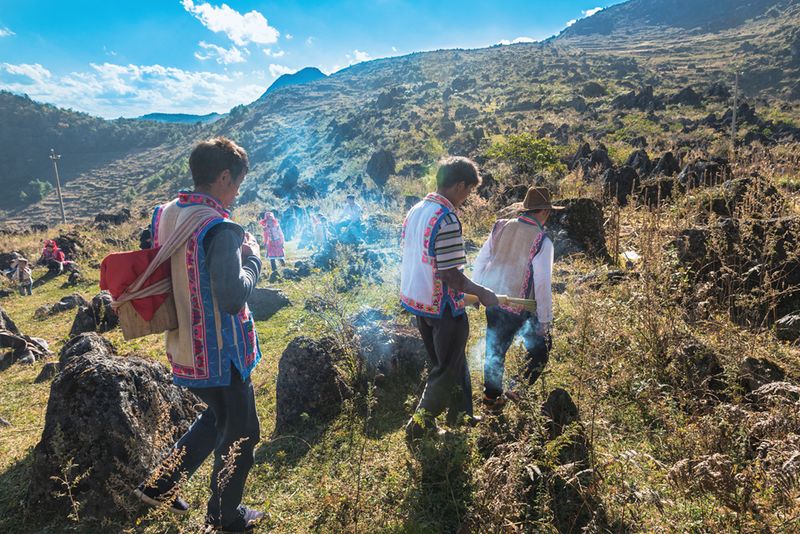 Shaman, the clan head, and family heads return the coffins to a secret cave until next year