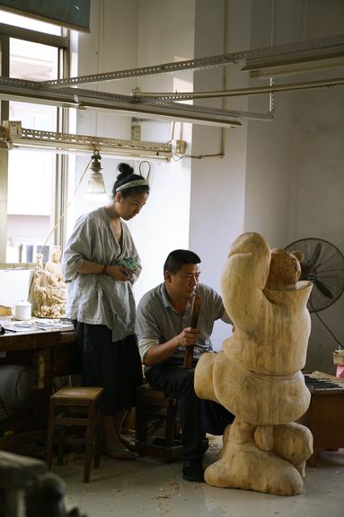 Wen Na and a colleague working on a sculpture in her Quanzhou studio