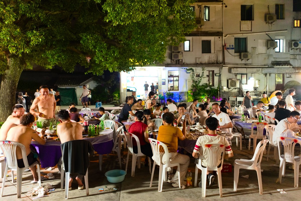 Vendors set up stalls and dining areas outside as the sun sets and the temperature cools on the island  (Evan Taylor)