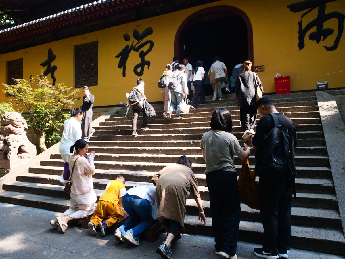 Visitors pray on the steps of Fayu Temple