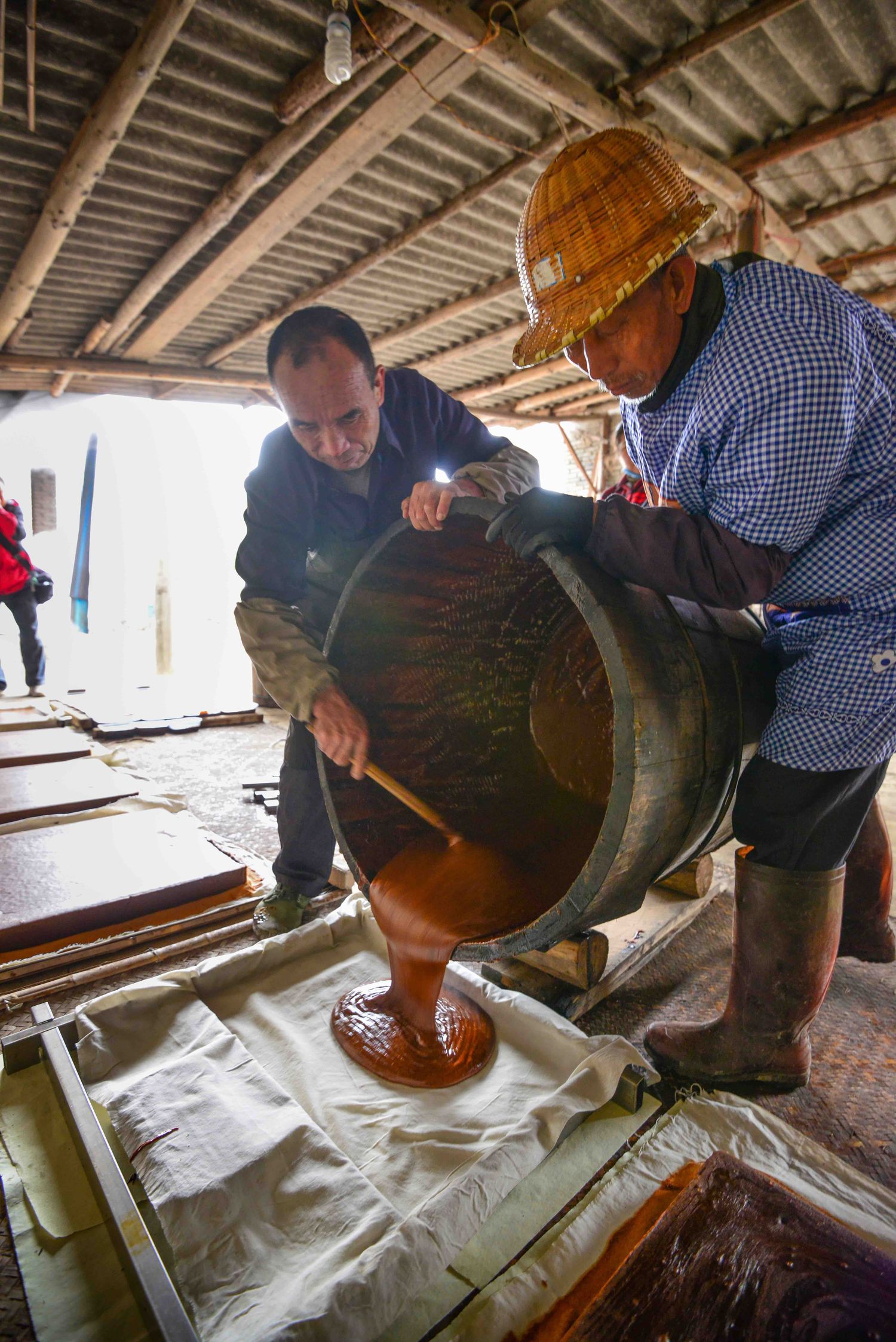 Workers pouring juice out onto a tray