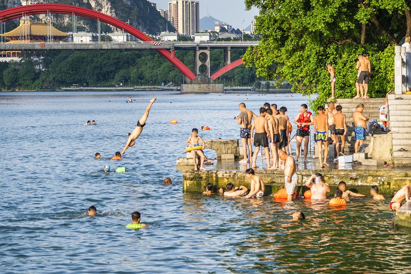 Locals dive into the Liujiang River next to Liuzhou in Guangxi