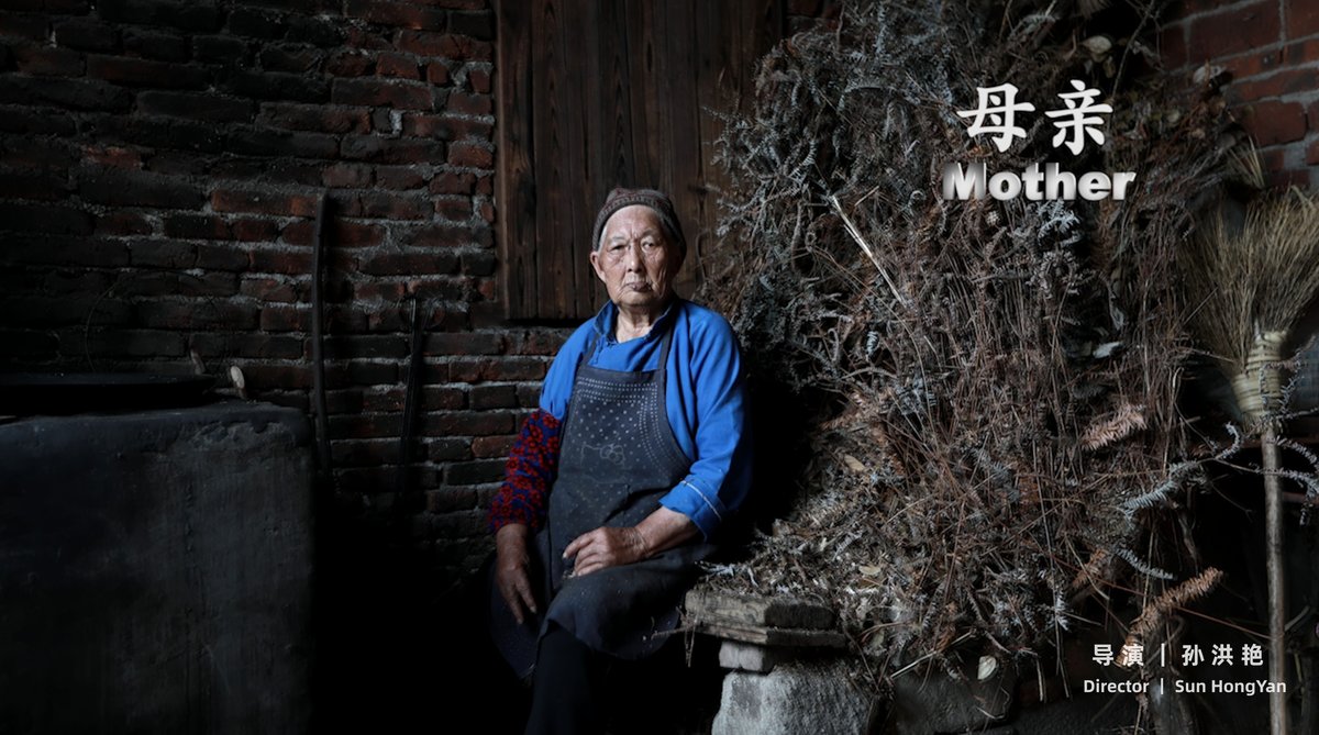 A poster showing an elderly woman sitting in her kitchen