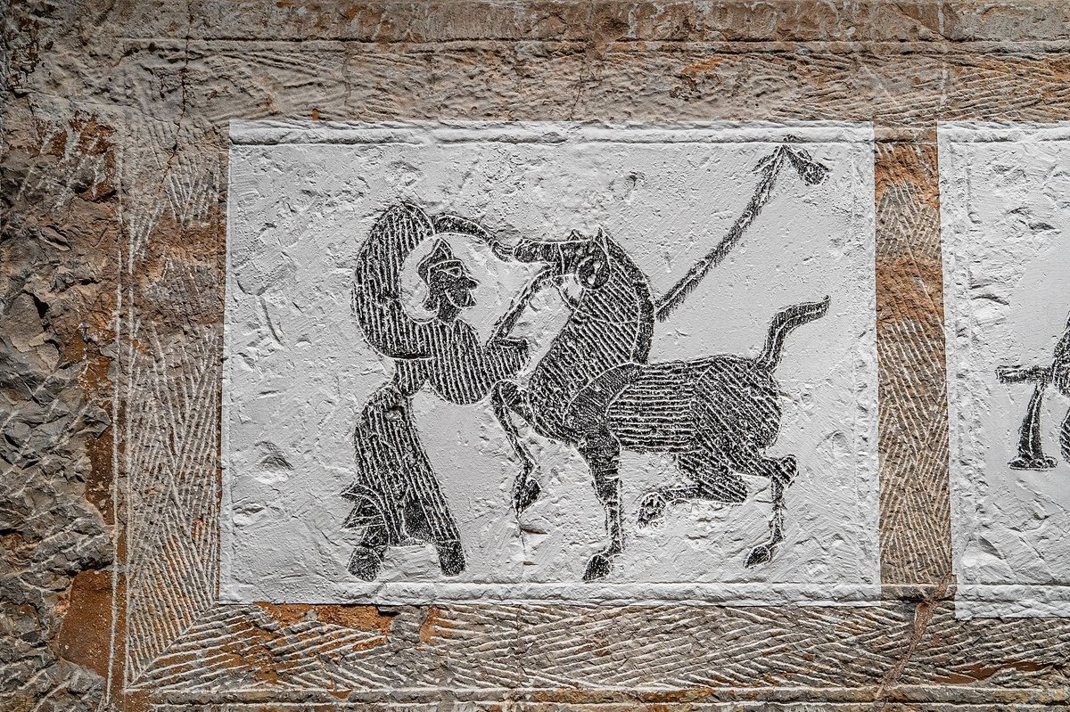 A modern sculpture of Bo Le examining a horse in a park in Qingdao, Shandong province