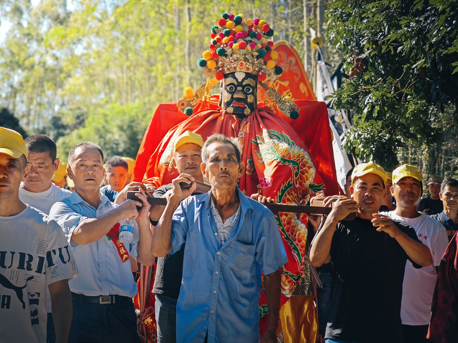 Villagers lifting ancestral lord