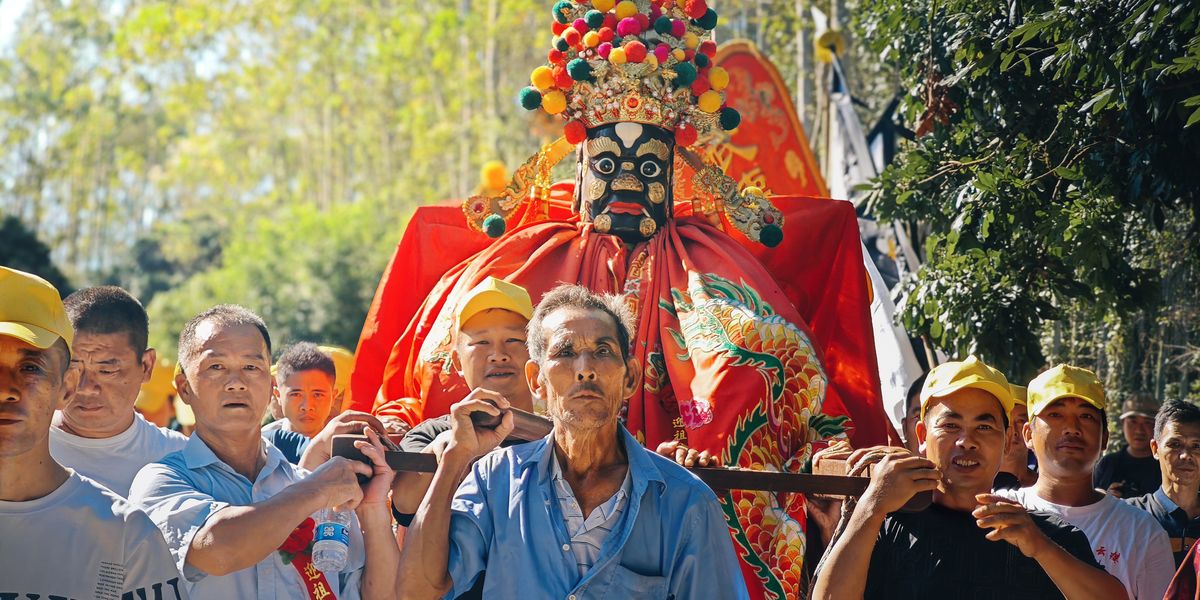 Villagers lifting ancestral lord