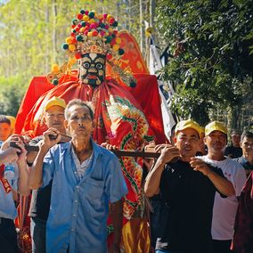 Villagers lifting ancestral lord
