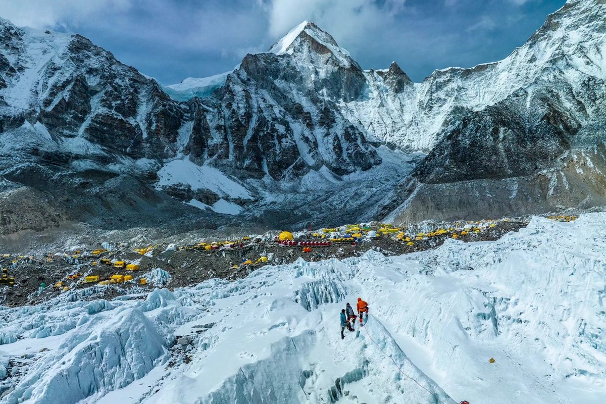 Mountain climbers set up camp at the base of the mountains