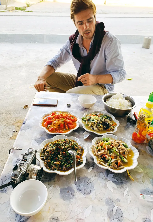 Mr. Konge enjoys local dishes at a roadside restaurant in Yunnan