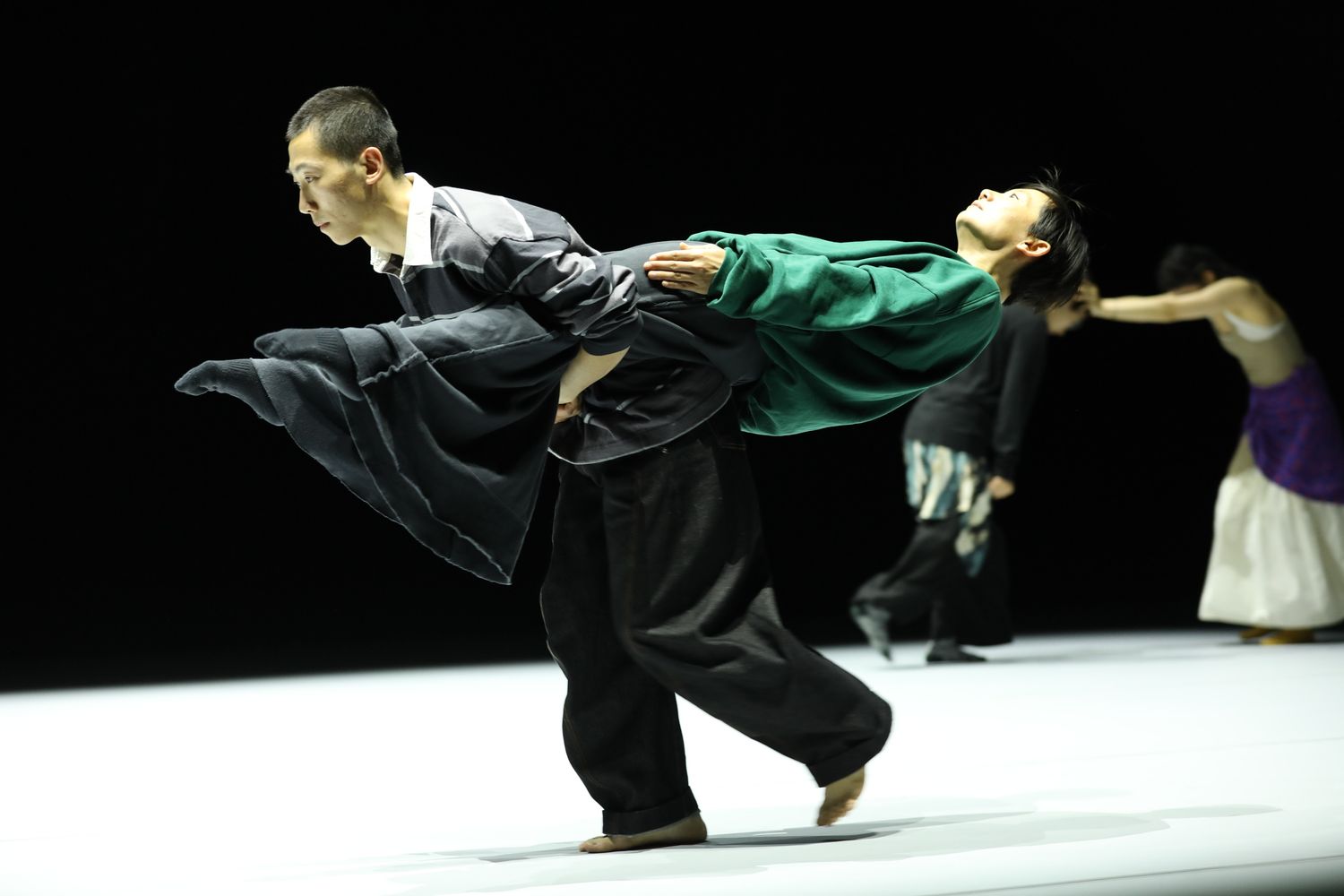 Jin Xiaoyan (right) and a member of TAO 1, the main ensemble, perform a challenging back-to-back somersault duet that tests balance and coordination