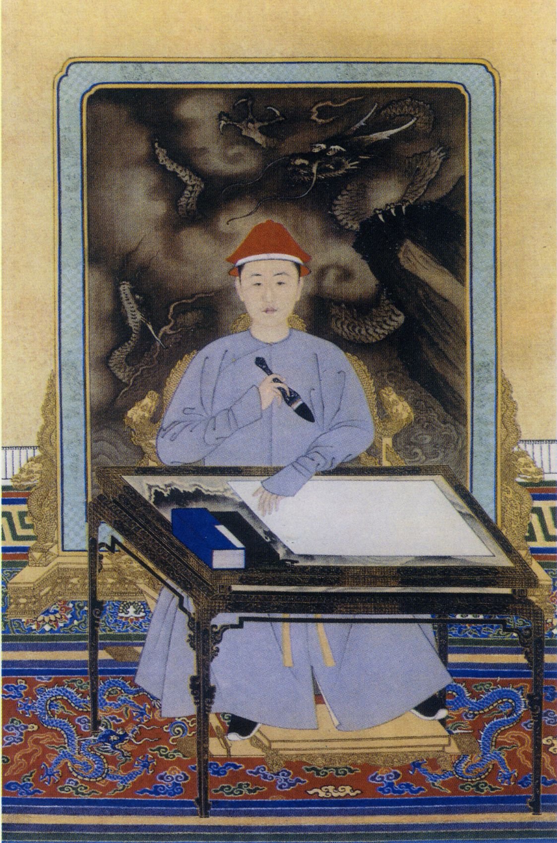 A young Kangxi Emperor in casual attire is depicted practicing calligraphy