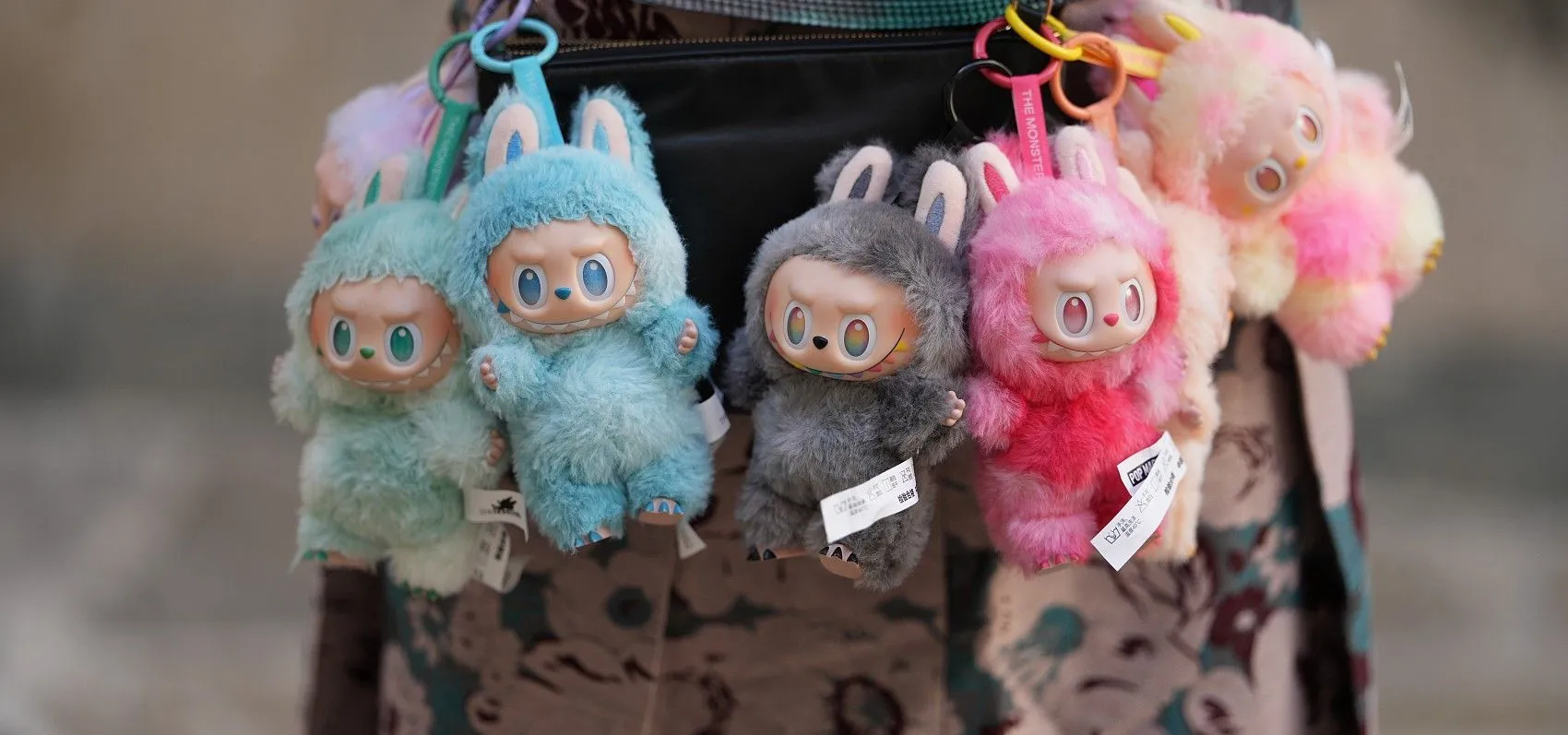 Labubu dolls hanging from bag