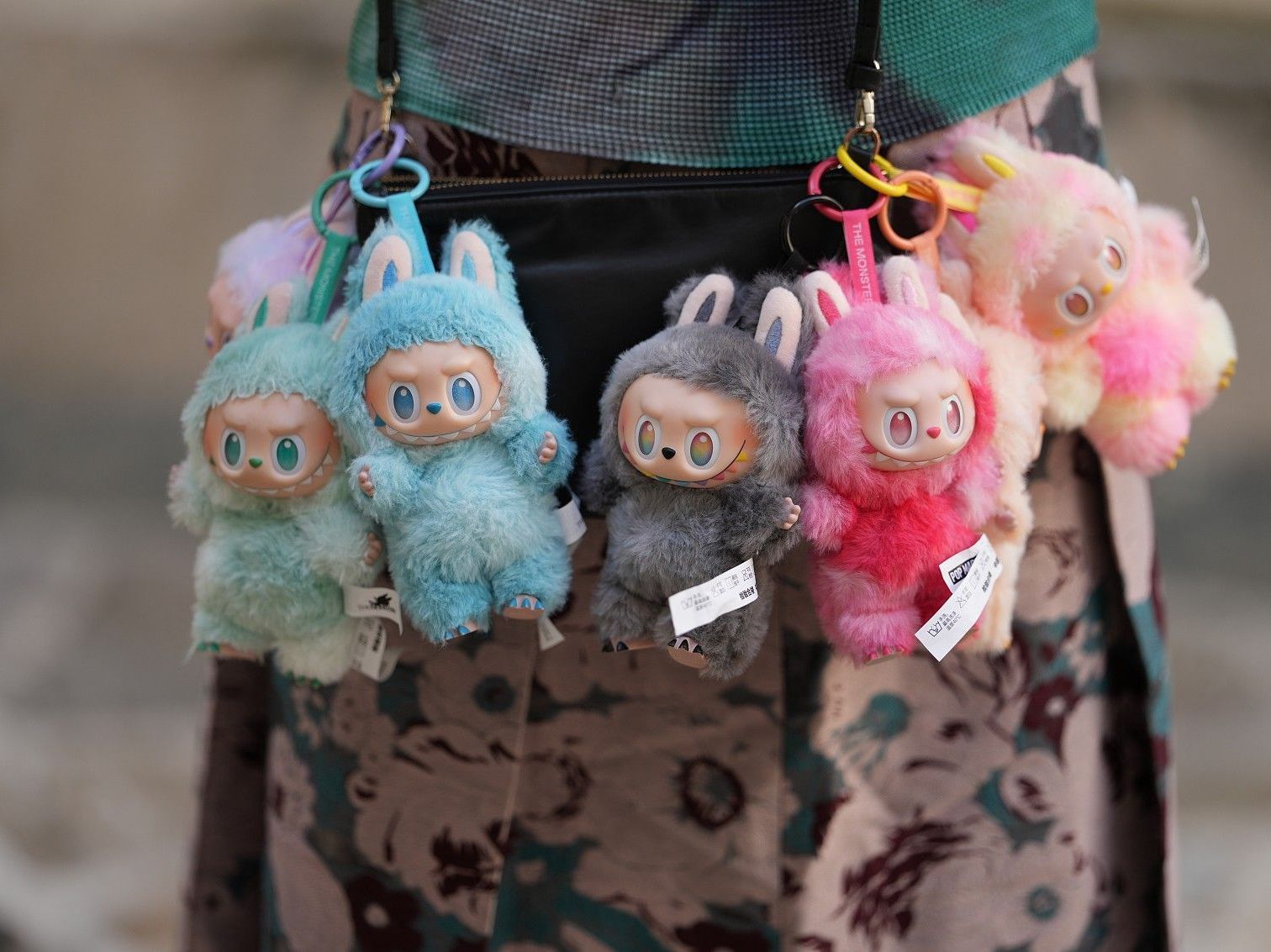 Labubu dolls hanging from bag