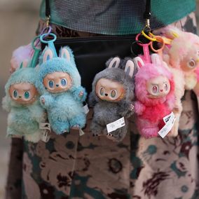 Labubu dolls hanging from bag