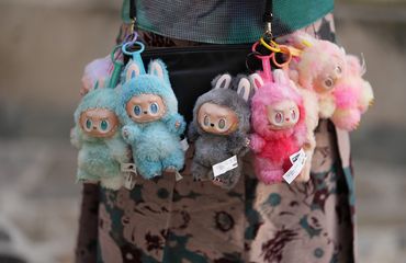 Labubu dolls hanging from bag