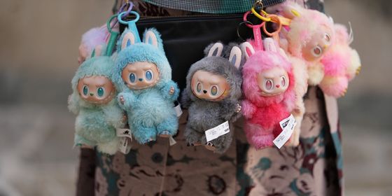 Labubu dolls hanging from bag