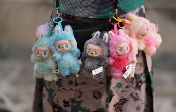 Labubu dolls hanging from bag