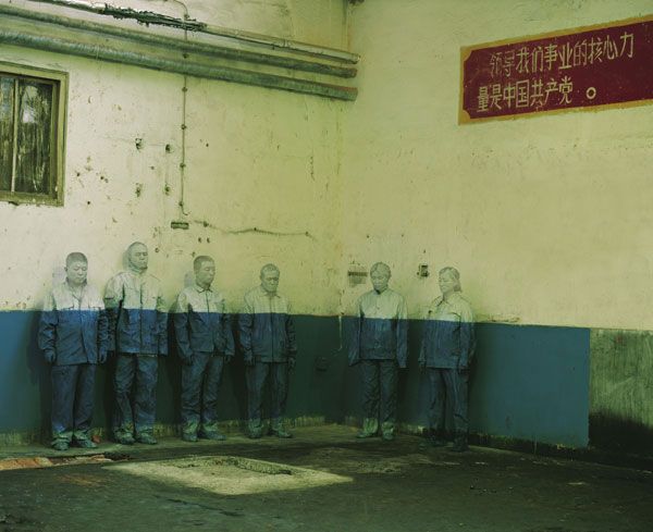 On the wall behind is a slogan of the Cultural Revolution: “The core force that leads us careering forward is the Chinese Community Party.”