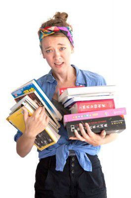 A girl struggles under the weight of all her Chinese books.