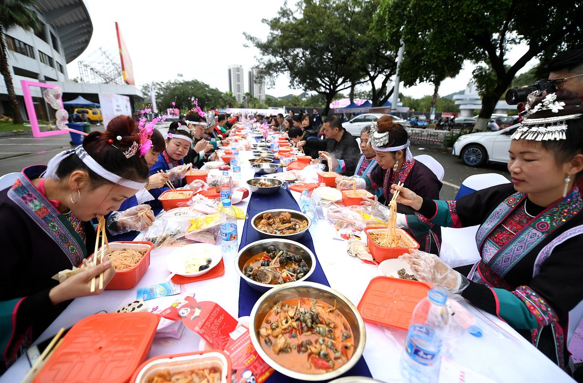 Locals participate in the Luosifen Long Street Feast in Liuzhou, Guangxi