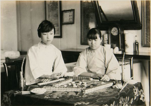Two Chinese women playing mahjong during the 1920&#x27;s. 