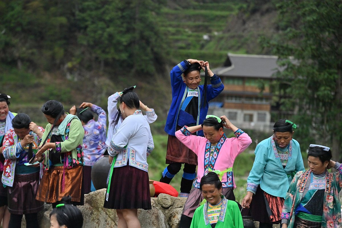 Miao minority women washing hair in Guangxi