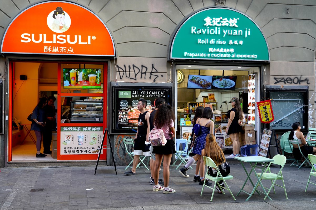 Pedestrians walking along Via Paolo Sarpi, the main drag of Milan's Chinatown