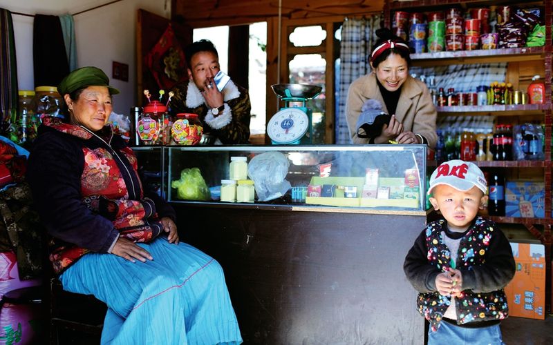 A Mosuo family hangs out at their convenience store
