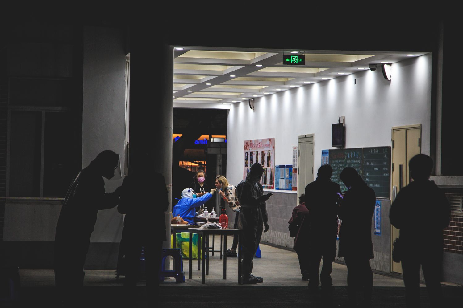 People queue while a medic administers a Covid-19 test, 12 days of Shanghai Lockdown