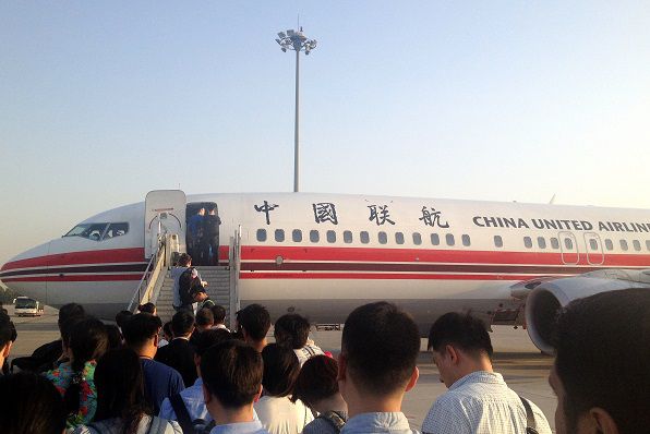 Passengers boarding the last China United Airlines flight from Nanyuan. 