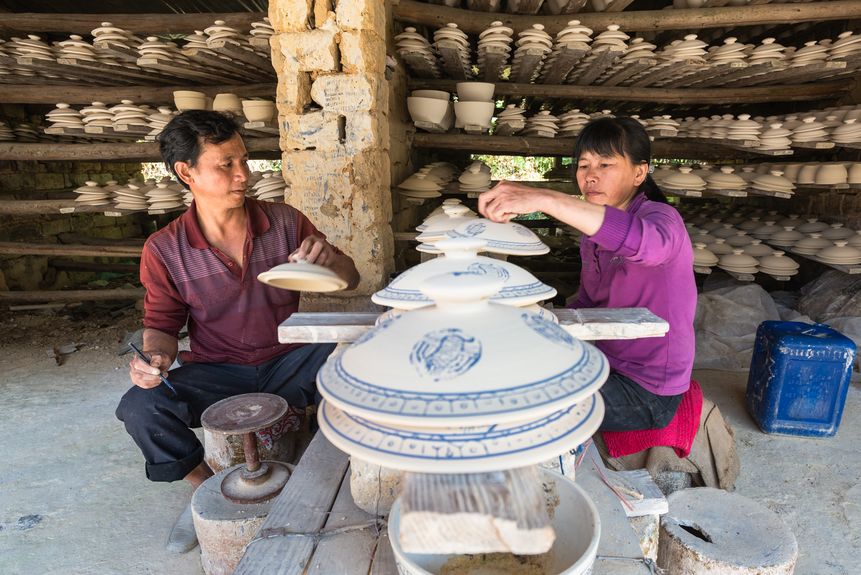 Artisans draw patterns on white clay to make blue and white porcelain in a workshop in Dapu county, Guangdong province (2013)