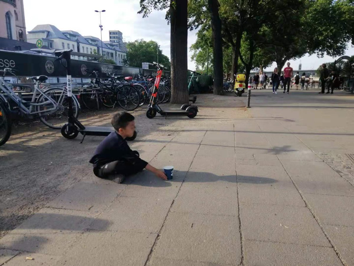 Lele begging on the side of a street