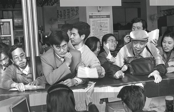 Shanghai residents waiting anxiously as they apply for a landline installation in 1994. 