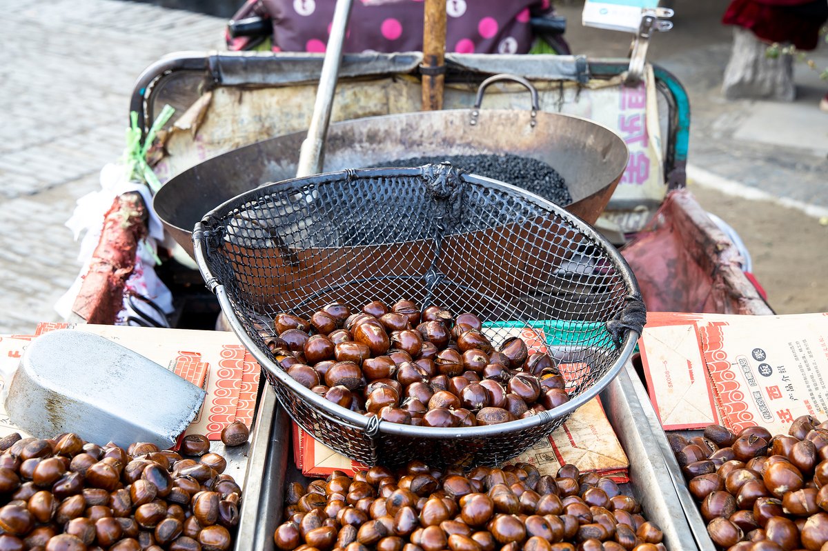 A street vendor selling freshly roasted chestnuts
