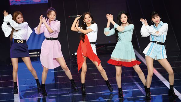 K-pop group (G)I-DLE performing on stage during a concert. 