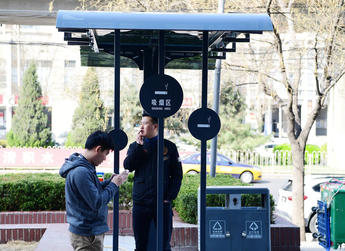 Chinese men having a smoke at a designated outdoor smoking spot in Chaoyang, Beijing, Smoke-Free Public Places in China