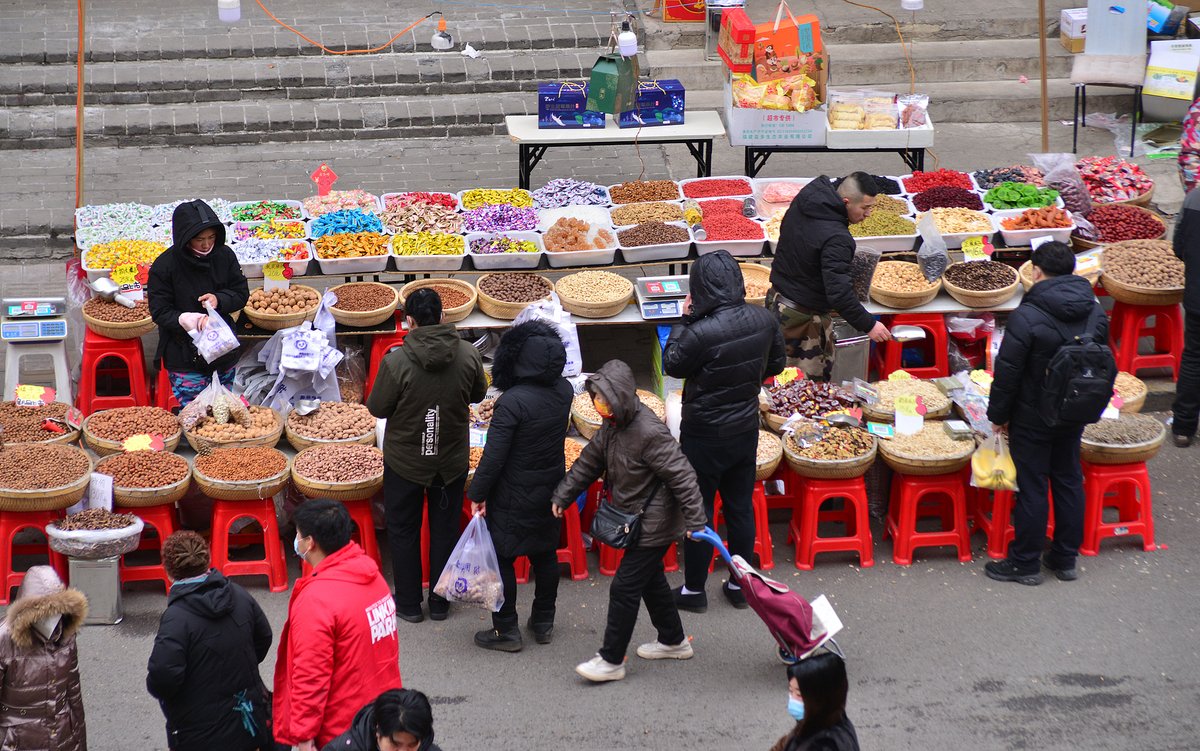 Locals buying nuts and snacks at a Spring Festival market in Shenyang, Liaoning