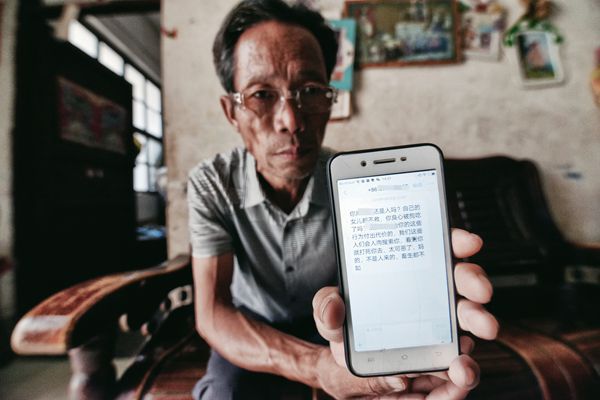 A Chinese father shares his phone screen which displays abusive comments received from online. 