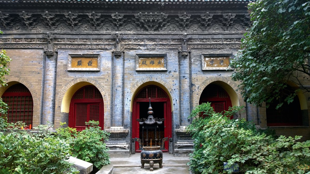 The brick temple hall, with characteristically northern features, houses the Buddha Amitabha