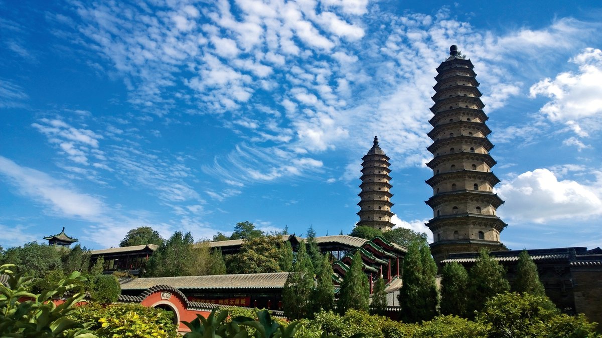The iconic twin pagodas stand against a blue sky