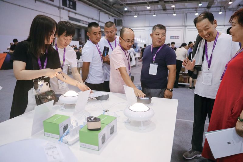 Local residents see a demonstration of smart speakers and lamps at an expo in Qingdao