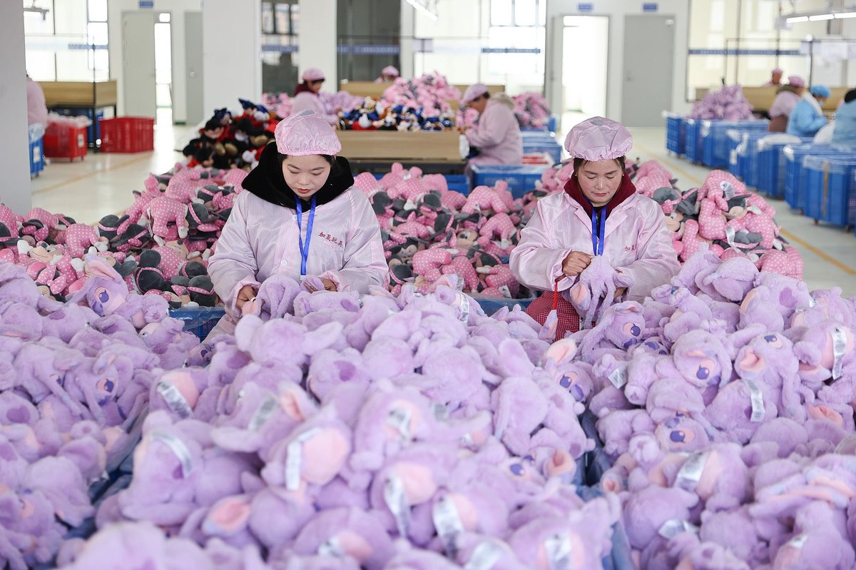 Workers making plushies for export in a toy factory in Lianyungang, Jiangsu province, China adults emotional economy