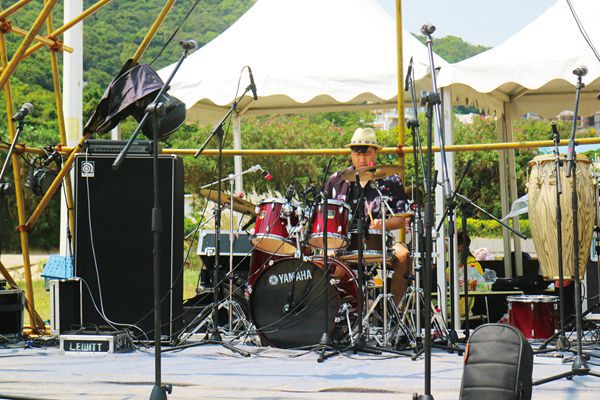 Chinese drummer drumming away during an outdoor music festival. 