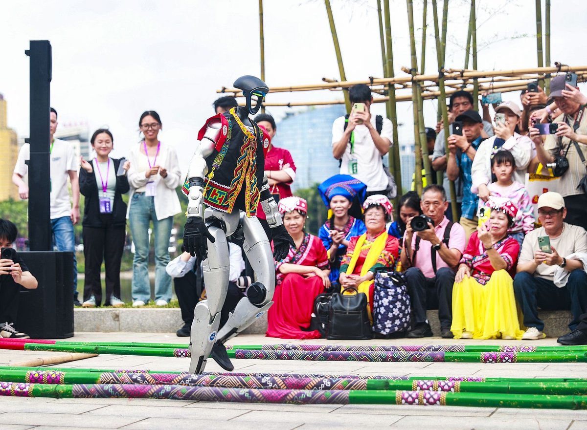 A Unitree robot joins the bamboo pole dance crowd at the Sanyuesan celebration in Nanning, Guangxi, this year, adding a touch of the future to the centuries-old festival.